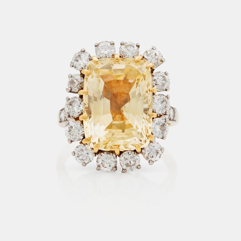 A 12.41 ct untreated yellow sapphire and brilliant cut diamond ring. Total carat weight of diamonds circa 1.95 ct.