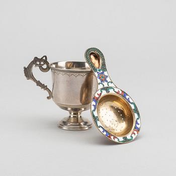 A russian cup and strainer in silver and enamel from 1896 and after 1958.