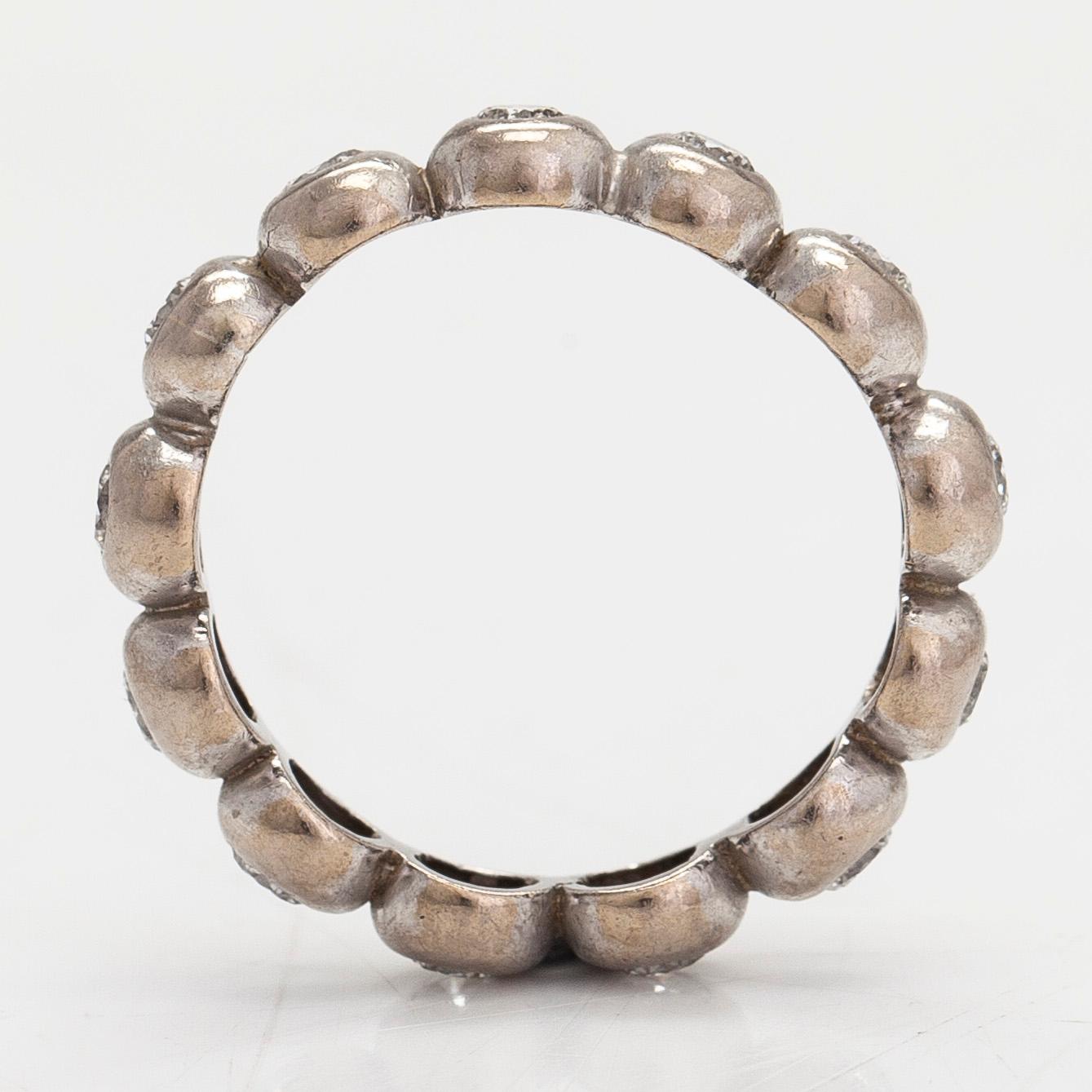 An 18K white gold eternity ring, with brilliant-cut diamonds totalling approximately 0.39 ct.