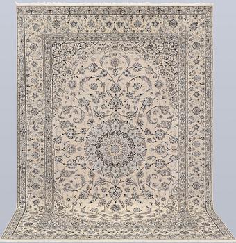A Nain, part silk carpet, 305 x 207 cm.