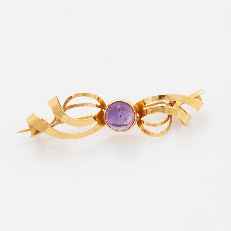 A pair of earrings and a brooch.