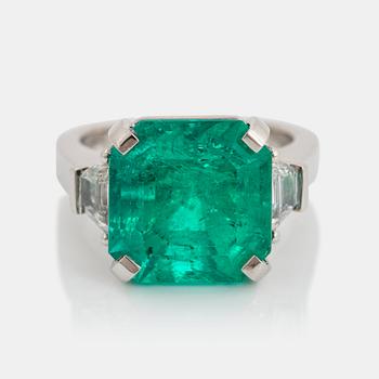 953. A platinum ring set with a Colombian emerald weight ca 10.40 cts.