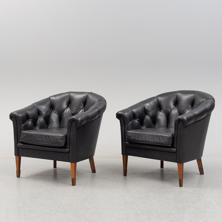 A pair of leather upholstered easy chairs, second half of the 20th Century.