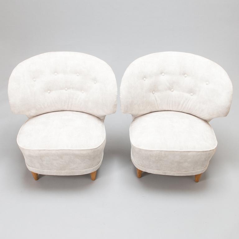 A pair of mid-20th-century armchairs.