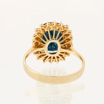 Ring in 14K gold with faceted sapphire and round brilliant-cut diamonds.