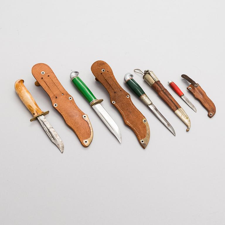 A set of four puukko knives and leather sheats, marked Olympia Helsinki -52.