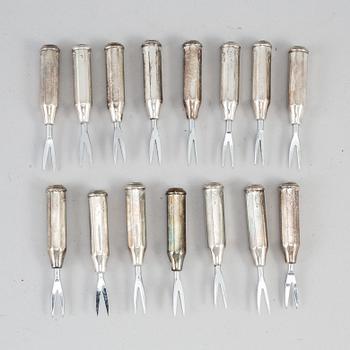 A set of seven con cob forks, sterling.