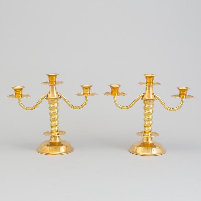 a pair of brass candelabras by Gottfrid Carlsson Eskilstuna.