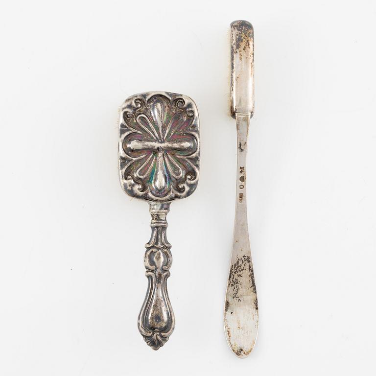 Two brushes, a hook, and a small mirror, silver and nickel silver.