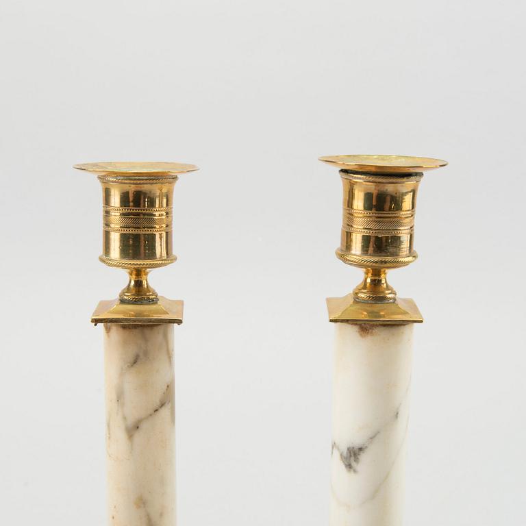 A pair of Late Gustavian marble candle sticks.