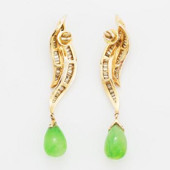 Baguette cut diamond and green stone earrings.