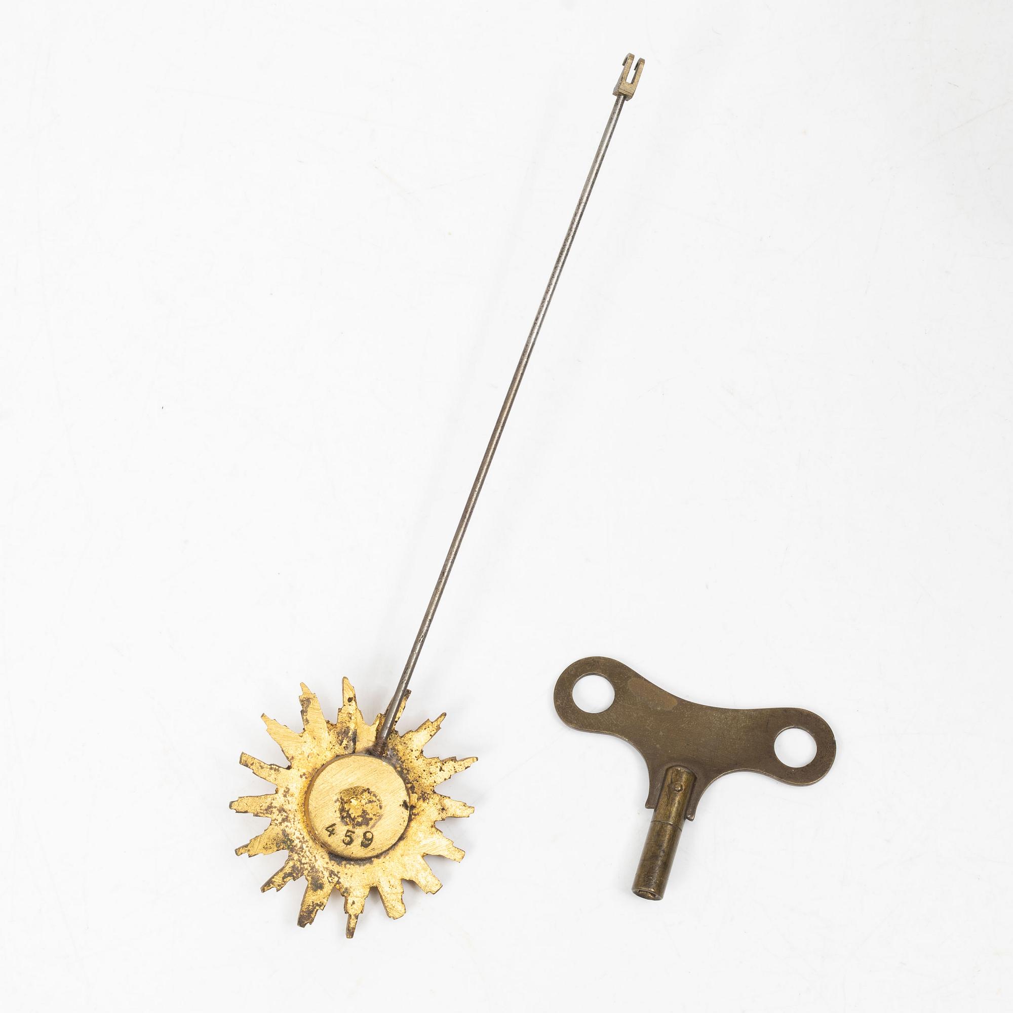 A Louis XVI-style mantle clock and a pair of candelabras. Early 20th century.