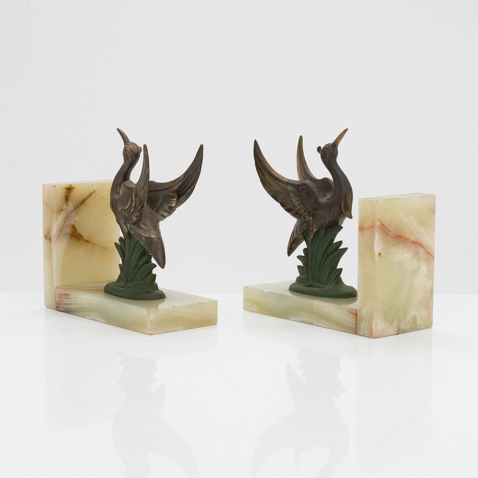 A pair of alabaster and  patinated metal Art Deco bookends from the first half of the 20th Century.