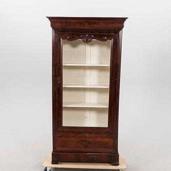 A walnut display cabinet around 1900.