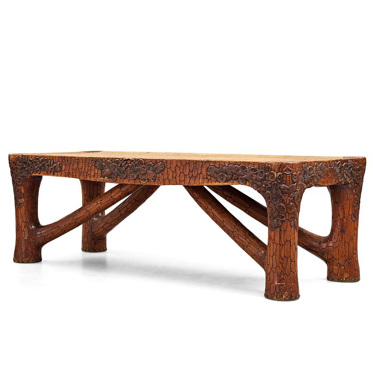 Gustaf Fjaestad, an Art Nouveau carved pine table, Arvika Sweden 1914, a double to the table in the Thiel Collection,