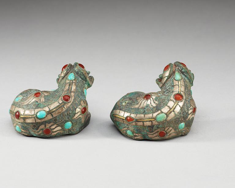 A pair of archaistic bronze figures of rams.