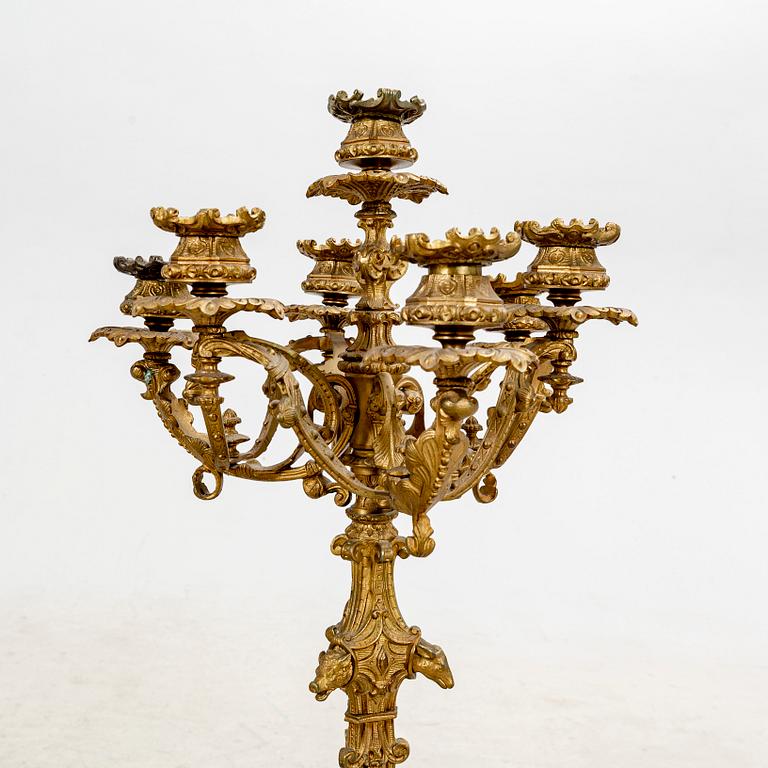 A pair of late 19th century metal candelabras.