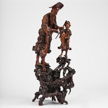 A large well sculptured root sculpture of 'Sholau and attendant', late Qing dynasty, 19th century.