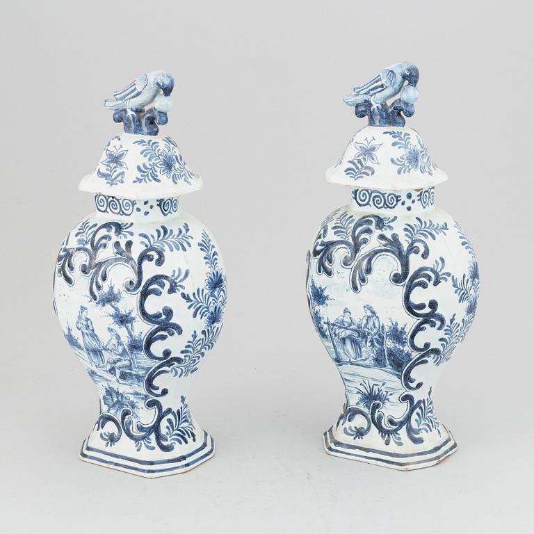 A pair of 19th century blue/white faience lidded jars, probably Dutch.