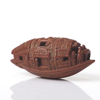 A Chinese nut boat sculpture, with poem.