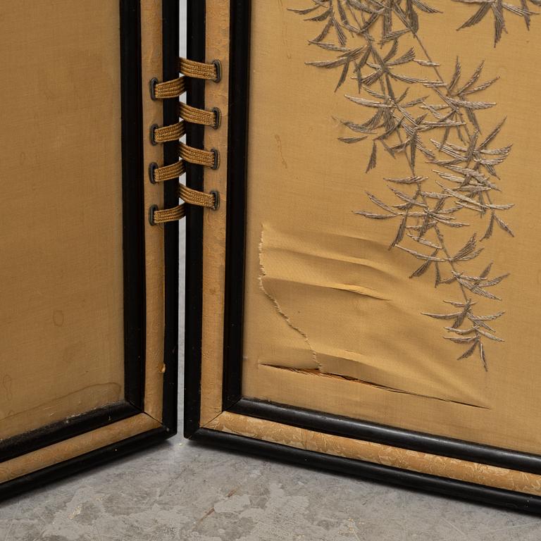 A Japanese silk embroidered four panel folding screen, first half of the 20th century.