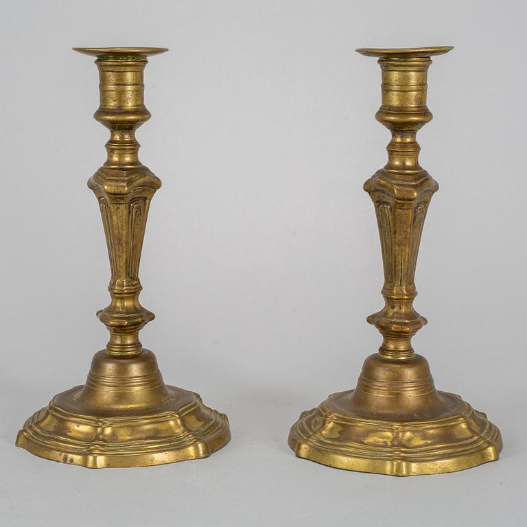 A pair of 18th century bronze candlesticks.