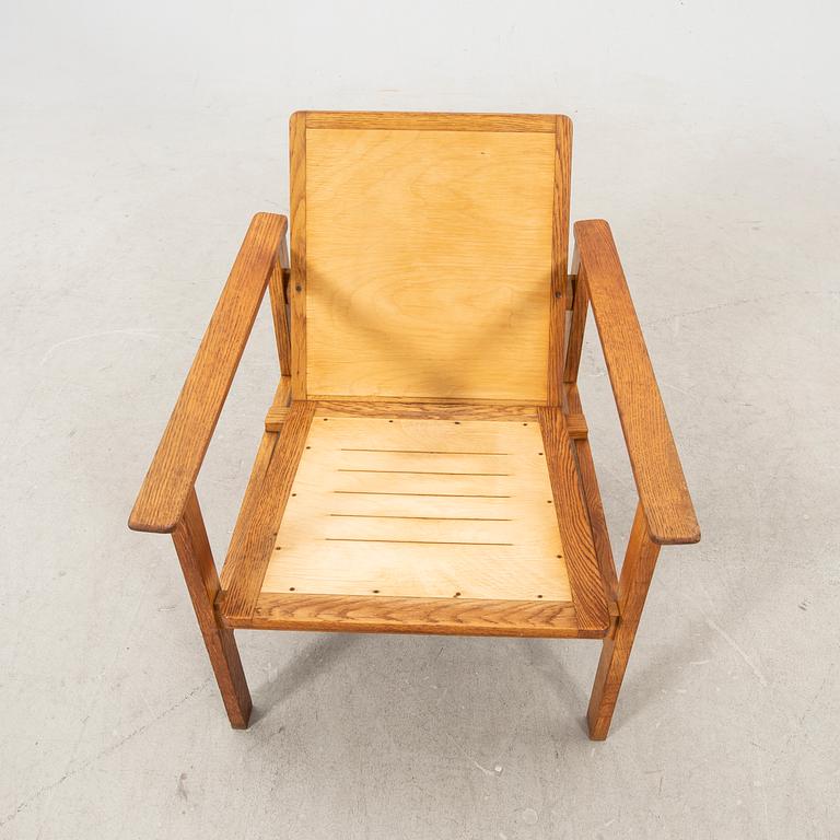 A stained wooden armchair later part of the 20th century.