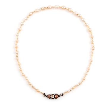 A pearl necklace with a silver and gold clasp set with rose-cut diamonds.