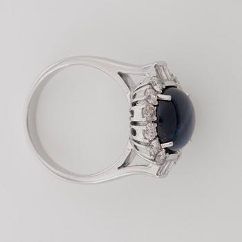 A 6.81 cts star sapphire and brilliant-cut diamond ring. Total carat weight of diamonds 1.05 cts.