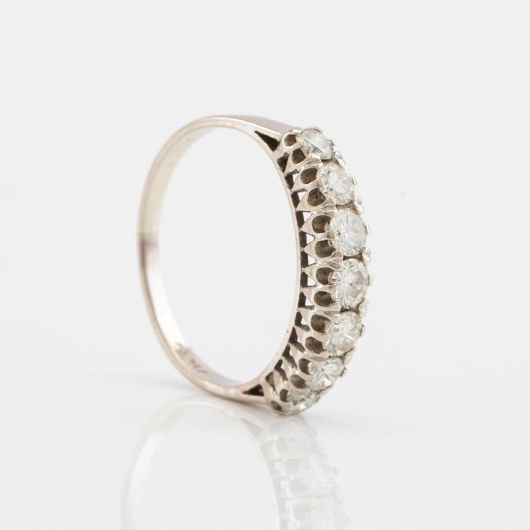 Half-eternity ring in 18K white gold set with round brilliant-cut diamonds.