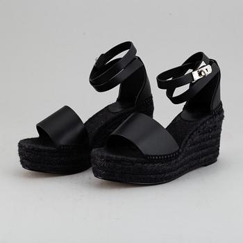 HERMÈS, a pair of black leather 'Tivoli' wedge sandals, 2019, size 38.