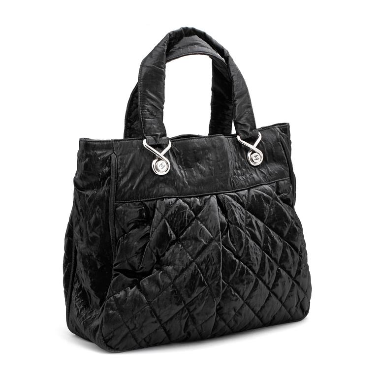 CHANEL a coated black quilted leather bag.