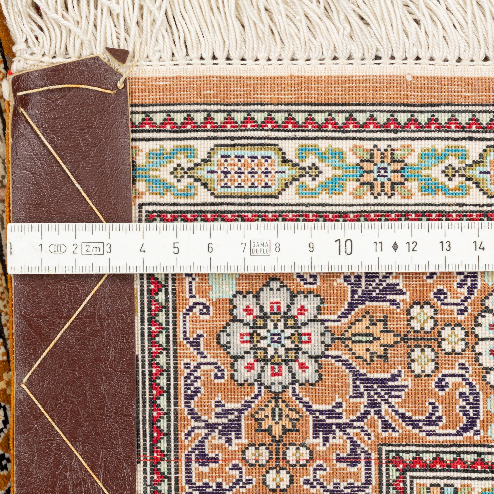 A carpet, oriental silk, circa 145 x 97 cm.