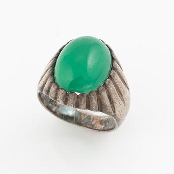 Silver ring with a green cabochon-cut stone.