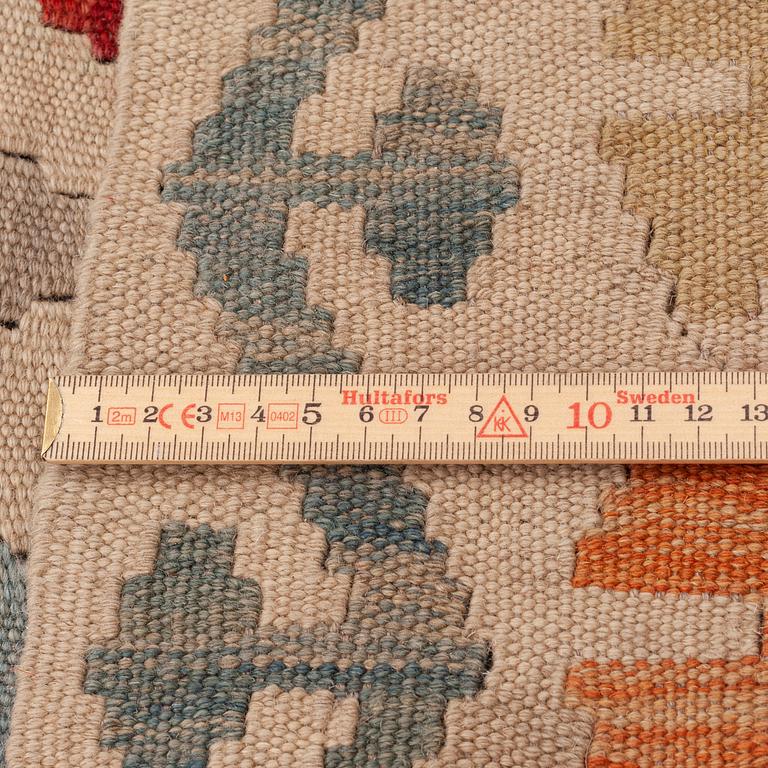 An oriental kilim, around 245 x 190 cm.