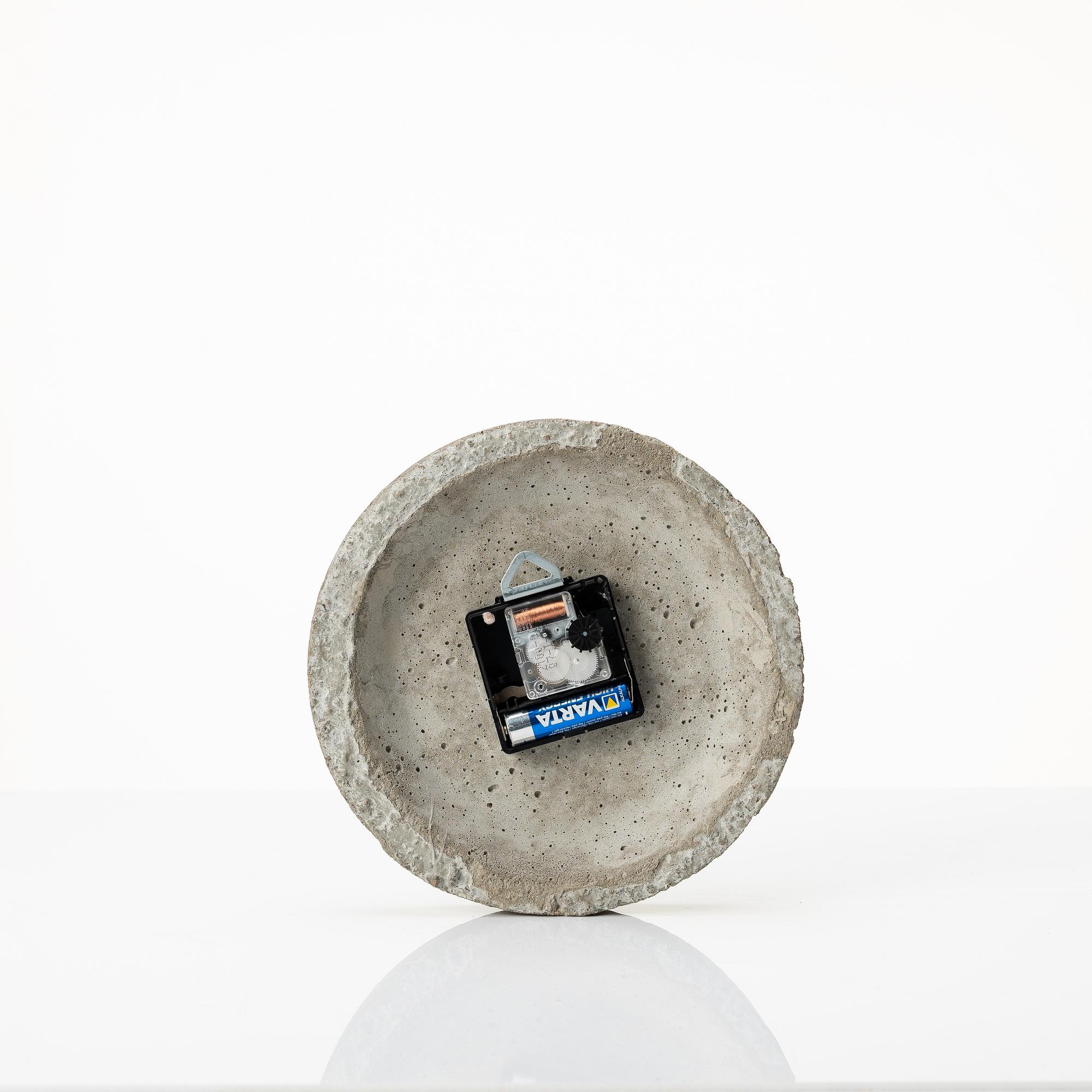 Stina Lindholm, a contemporary concrete planter 'Spira', a concrete flower pot and a wall clock.
