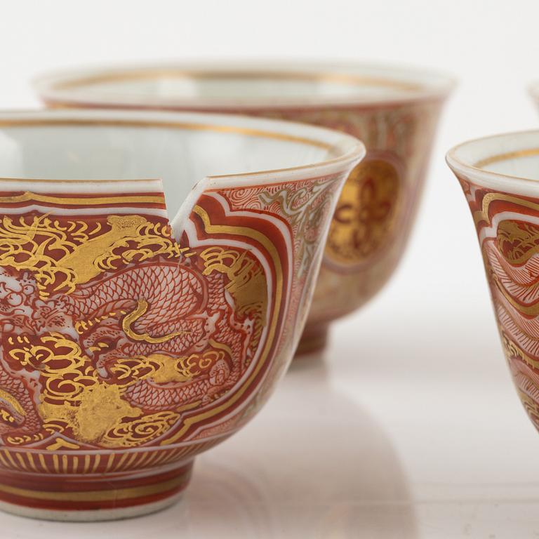 A set of four iron red and gilded wine cups, Japan, early 20th Century.