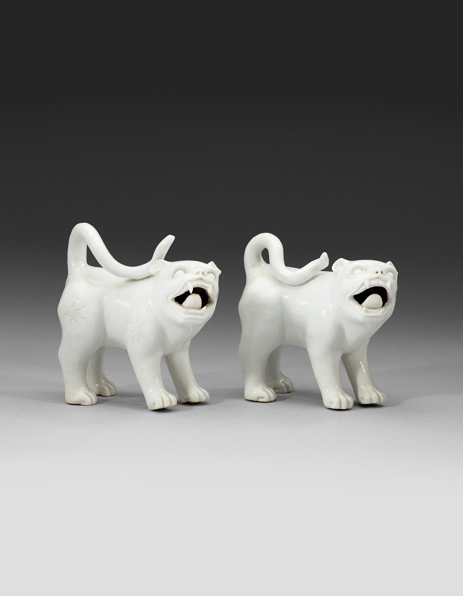 A set of two blanc de chine mythological animals, late Qing dynasty.