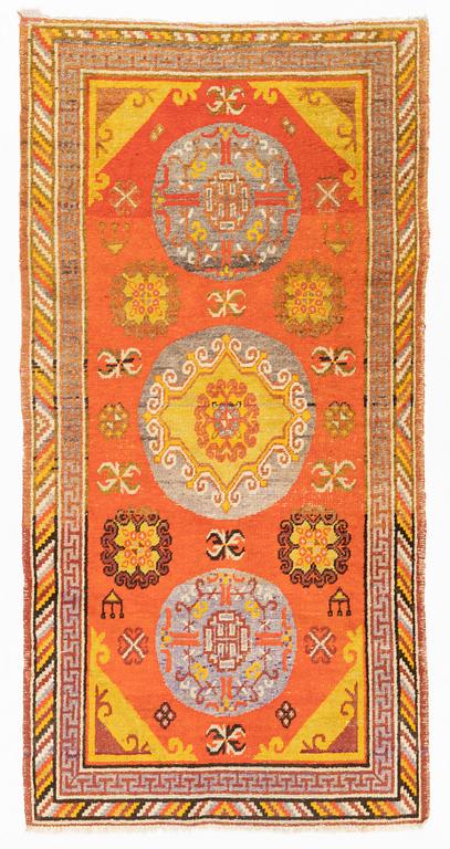 A Carpet, Khotan (?), 217 x 108 cm.