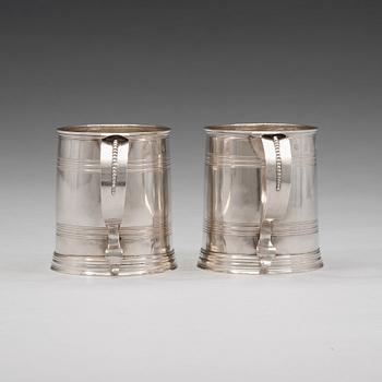 A pair of English early 18th century silver muggs, mark of John Cory, London 1704.