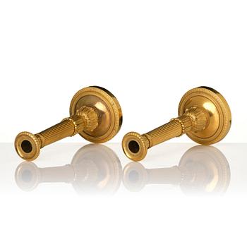 A pair of French Empire gilt-bronze candlesticks, early 19th century.