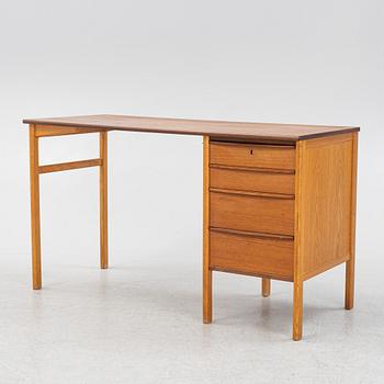 A teak veneered writing desk, 1960s.