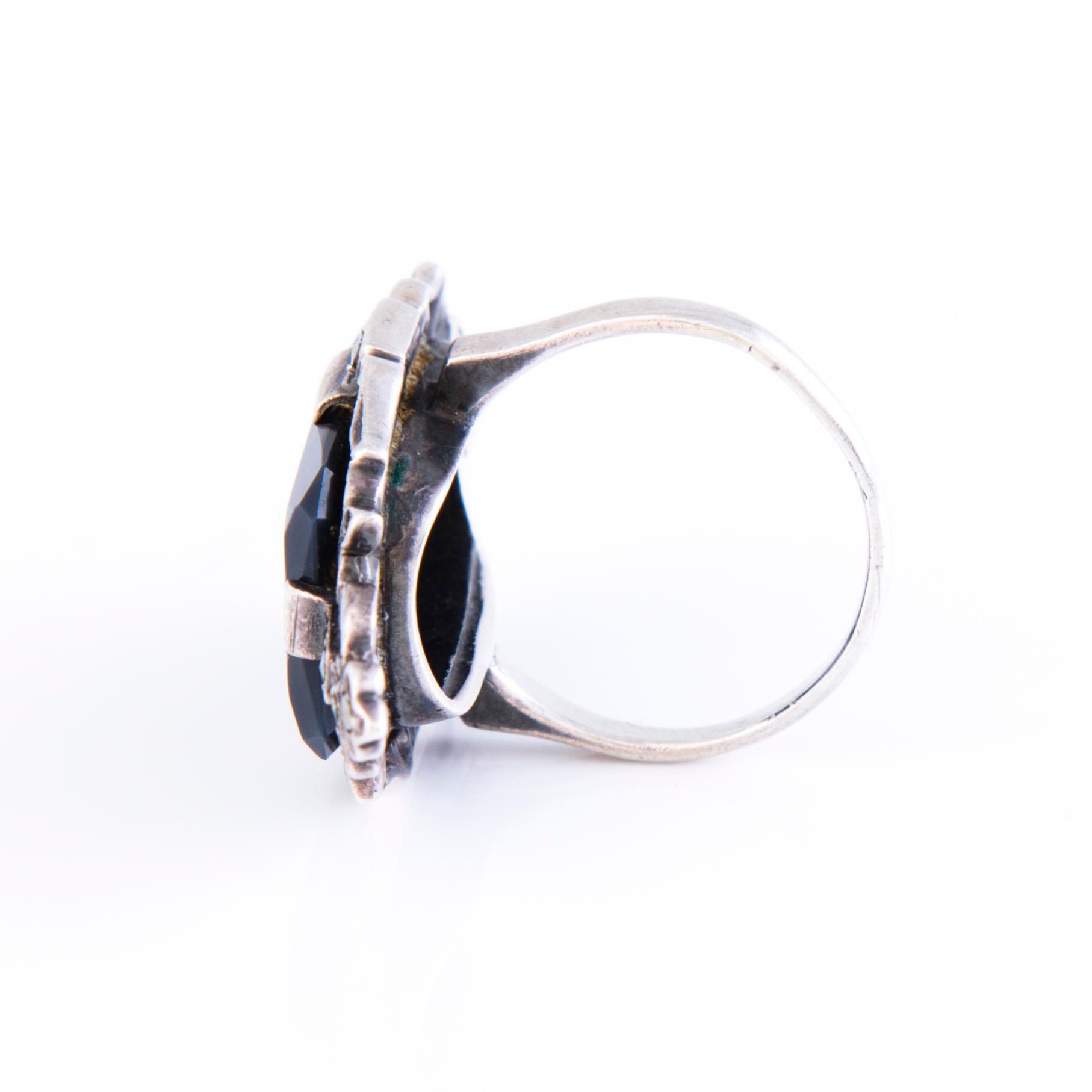 Four Art deco jewelry, ring, pendant necklace and earrings in silver.