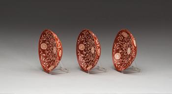 A set of three coral red dishes, Qing dynasty, with Daoguang seal mark.