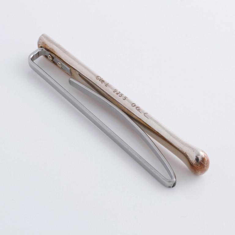 A tie clip by Ole Lynggaard.