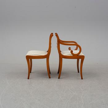 a late 20th century dining table with eight chairs.