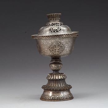 A Tibetan silver butter lamp with cover, 19th Century.