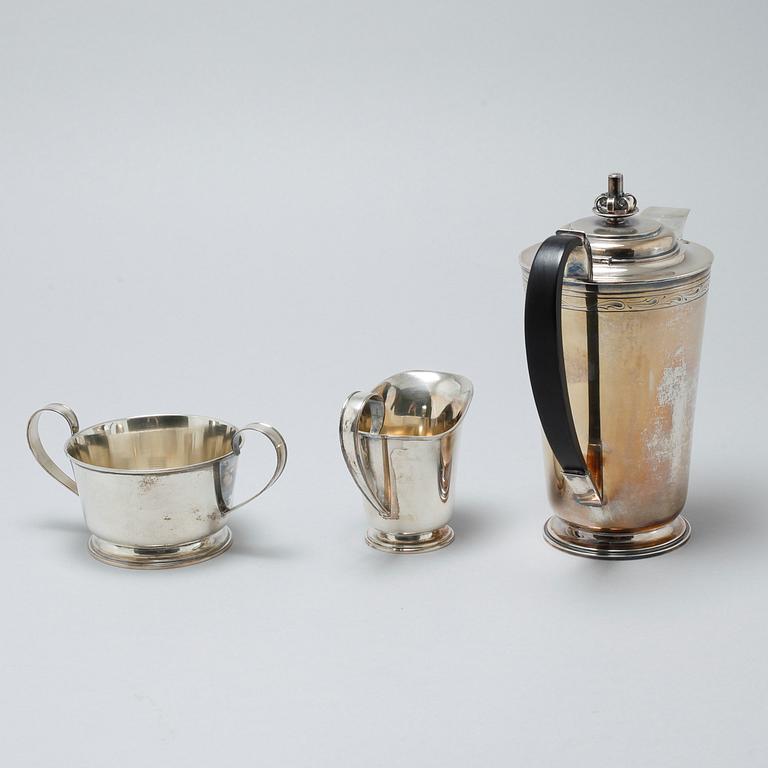 A silver coffee pot, sugar bowl and creamer by Thore Eldh for K&EC in Göteborg, 1949.