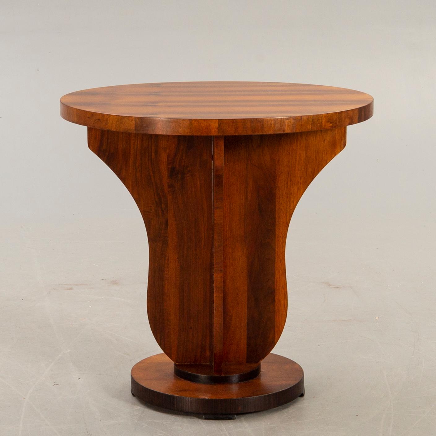 An Art deco style walnut table later part of the 20th century.
