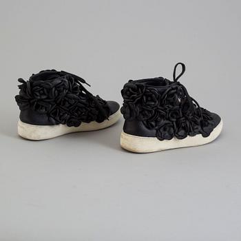 A black leather sneakers by Chanel.